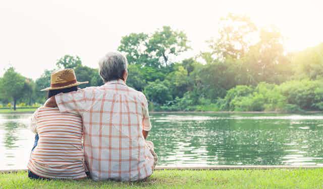 Elderly couple looking at a lake.