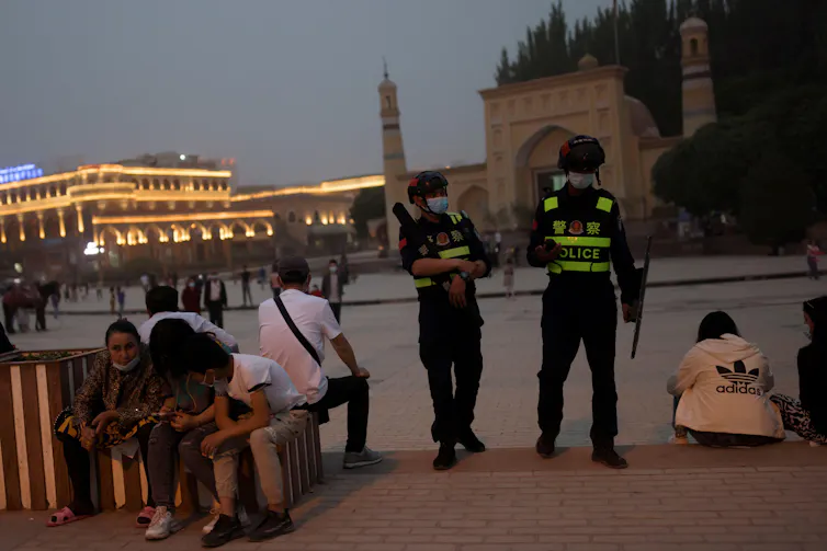 Police officers patrol the square in front of Id Kah Mosque in Kashgar.