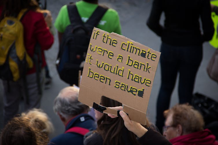 A sign reading 'If the climate were a bank it would have been saved'