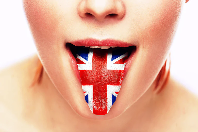 Close-up of a person sticking their tongue out which is painted with the UK flag union jack