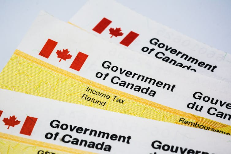 Three government of Canada 'income tax refunds' are laid on top of one another