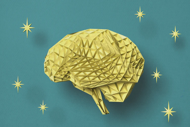 Illustration of brain made of folded yellow paper on a teal background, surrounded by eight-pointed stars.