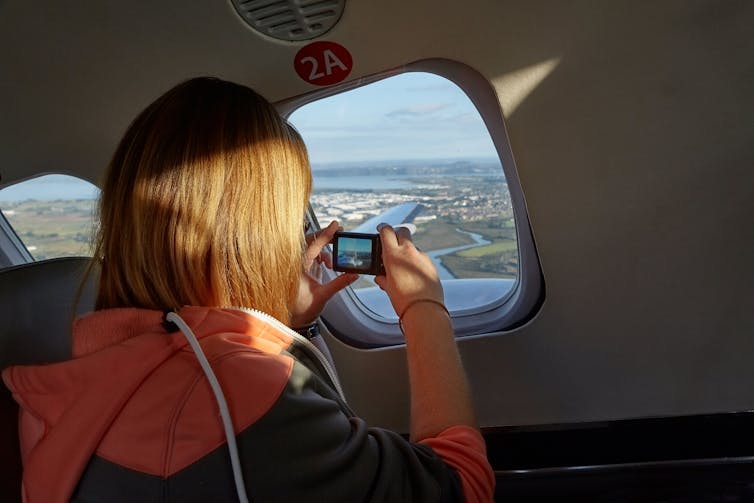 Woman taking picture from small plane