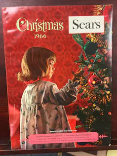Catalogue cover showing child looking at a Christmas tree.