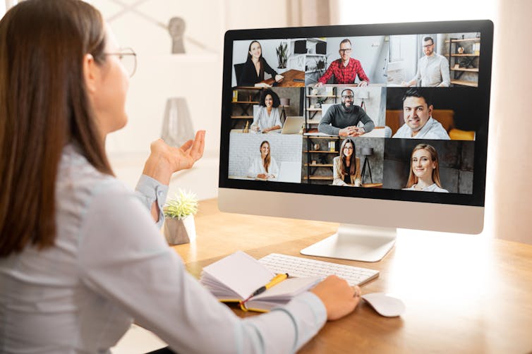 Woman talks to a group of people on her computer screen