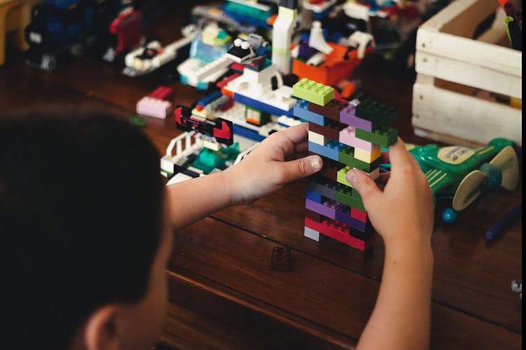 Child playing with Lego