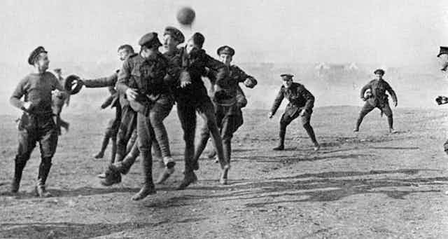Soldiers scramble to head a ball.