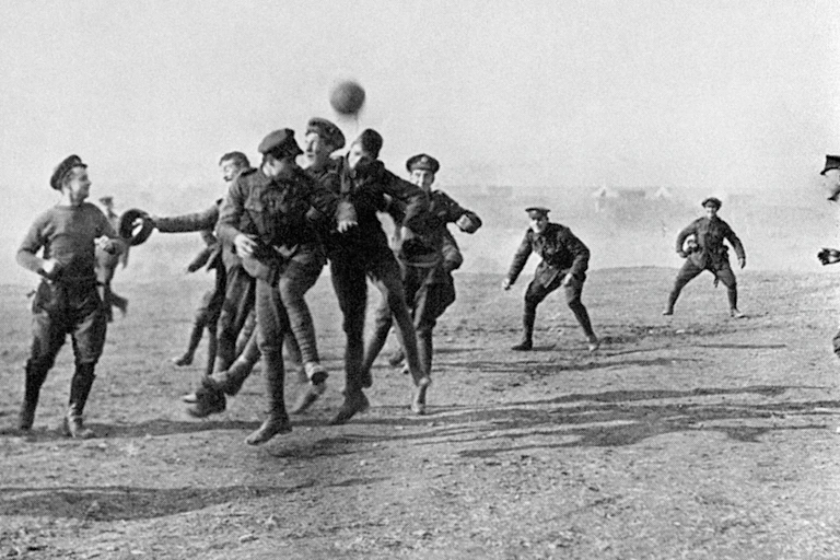 Soldiers scramble to head a ball.