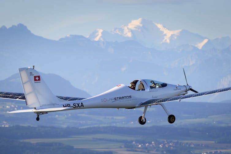 A solar powered aircraft prototype flies in mountainous terrain