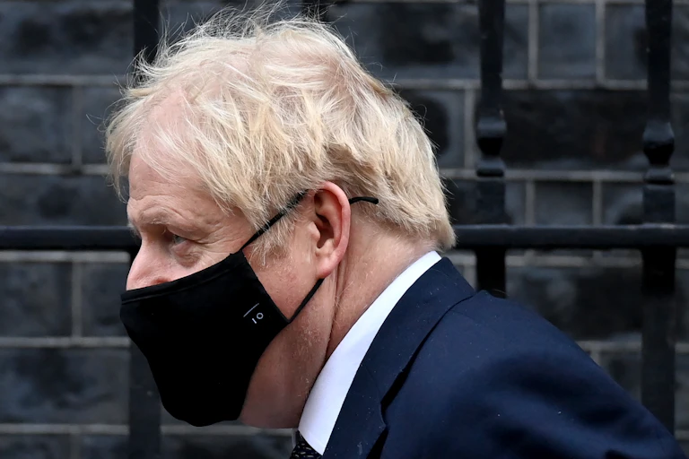 Close up profile shot of Boris Johnson wearing a Number 10 face mask