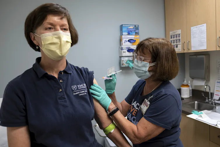 A medical professional getting a shot.