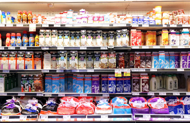 Selection of milk and dairy products on shelves in a supermarket