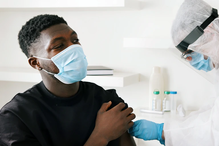A man being vaccinated for COVID