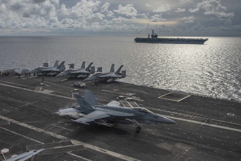 The USS Ronald Reagan and USS Nimitz sailing in the South China Sea