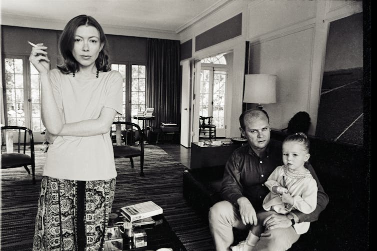 Joan Didion in her living room with her husband and daughter.