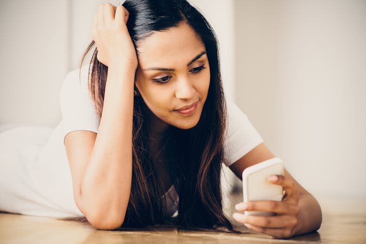 Young woman looking at mobile phone.