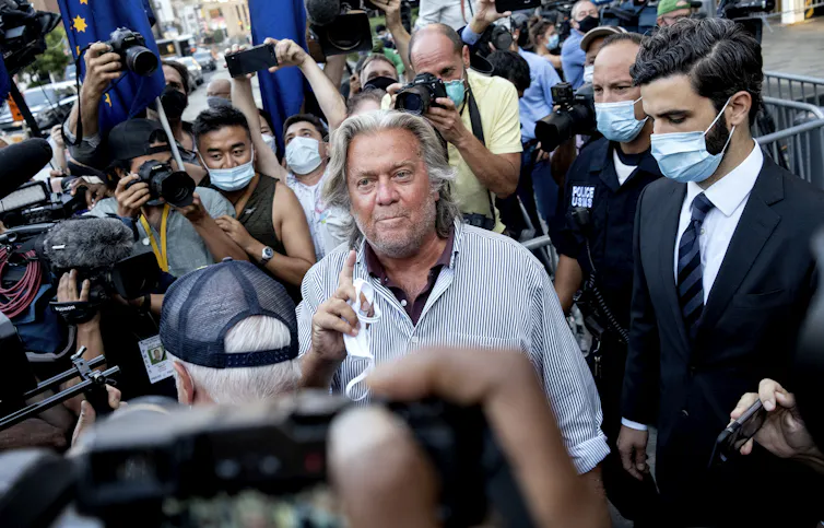 Former White House aide Steve Bannon surrounded by photographers