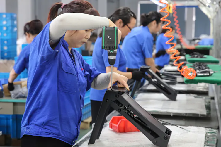 Workers build desks.