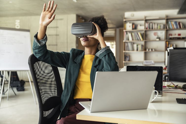 A woman wearing virtual reality goggles.