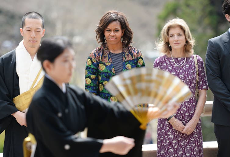 Caroline Kennedy and Michelle Obama watch a performance in Japan.