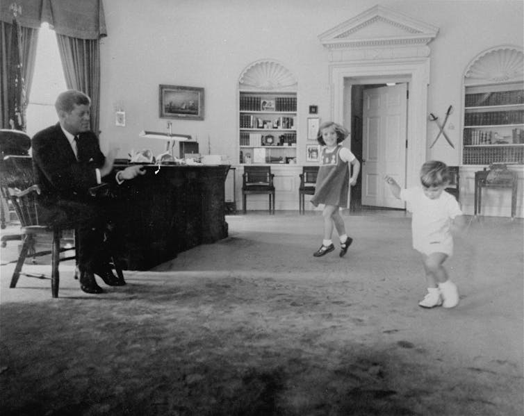 Caroline Kennedy and her brother, Robert junior dance in their father's White House office in 1962.