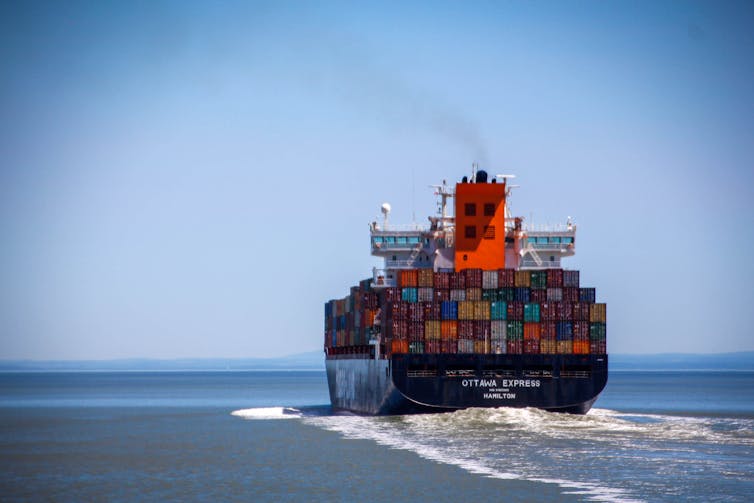 A boat carrying containers on the sea