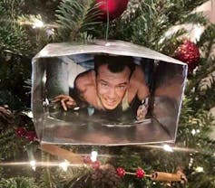 Diehard's John McLane trapped inside a Christmas decoration that looks like a heating duct.