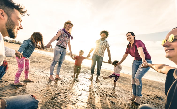 Group of adults and children on the beach