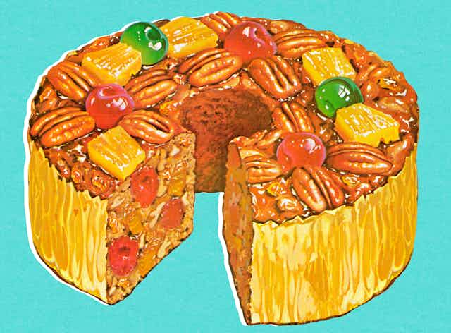 Colorful fruitcake with one slice removed.