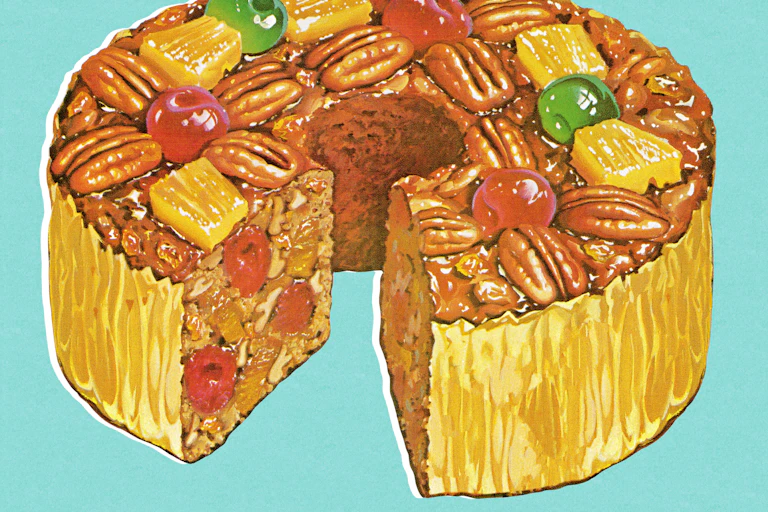 Colorful fruitcake with one slice removed.