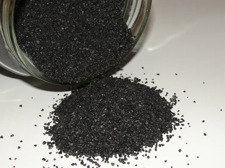 A pile of shiny black powder and a jar