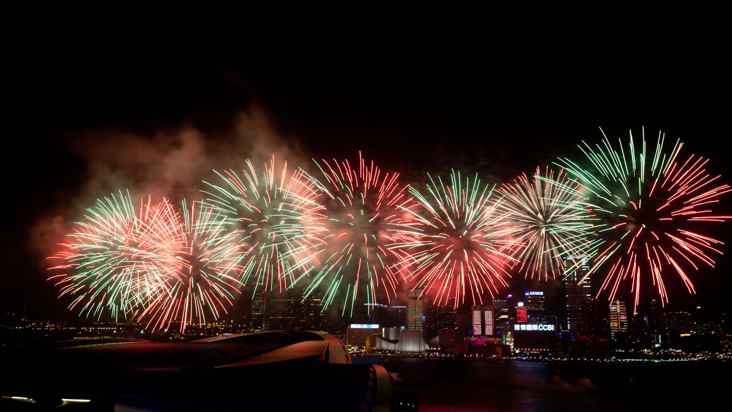 A mix of red, yellow and green firework explosions.