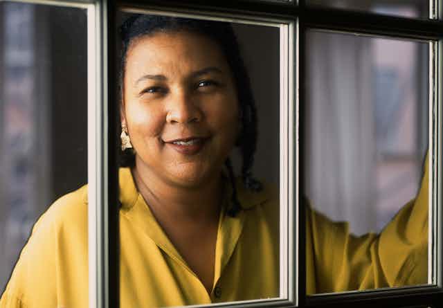 bell hooks looks out through a window.