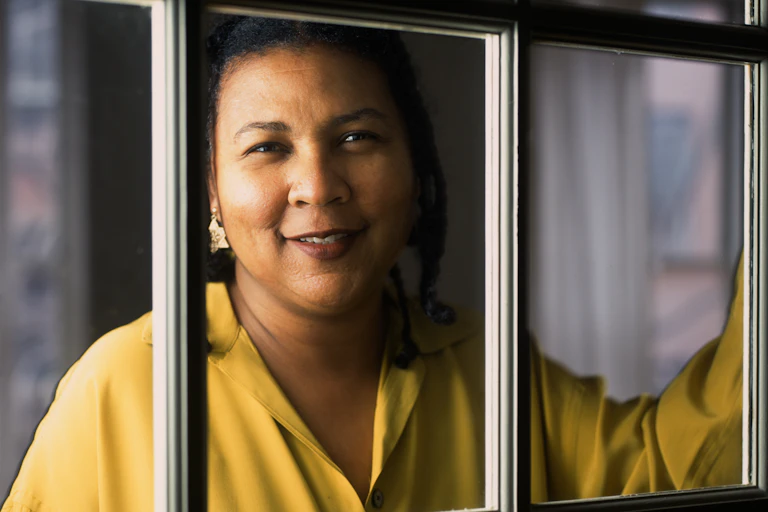 bell hooks looks out through a window.
