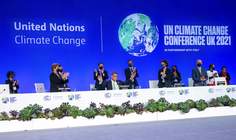 The closing plenary of COP26 with Alok Sharma in the centre receiving a standing ovation.