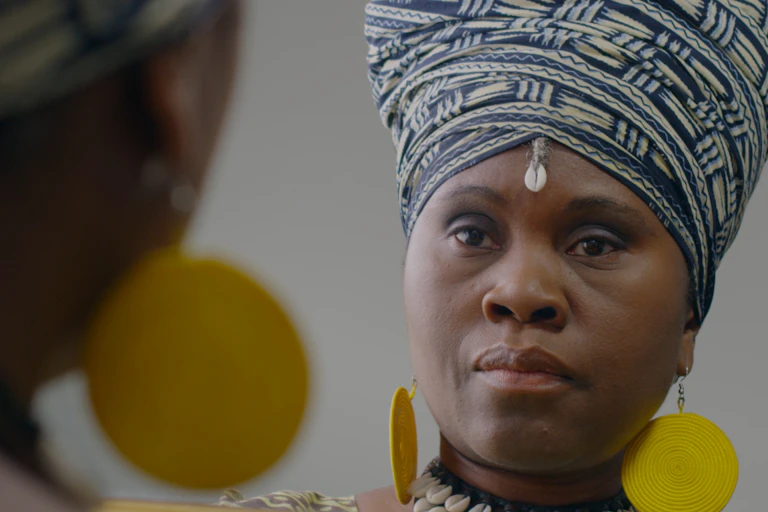 A woman seen looking in the mirror.