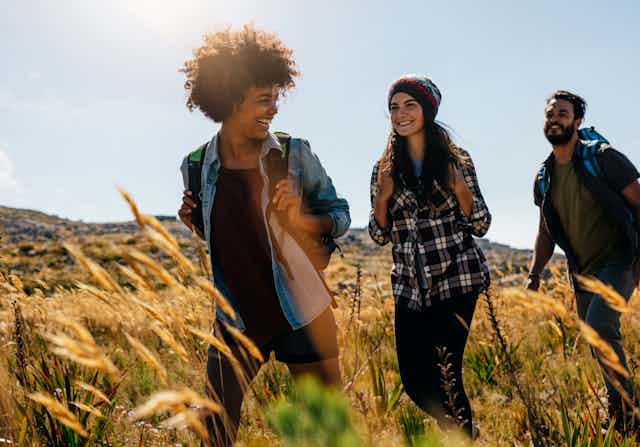 Friends walking together through a field