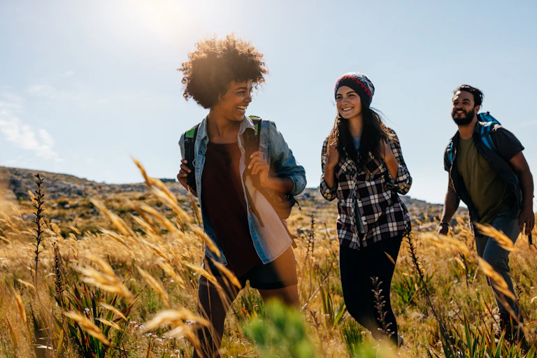 Friends walking together through a field