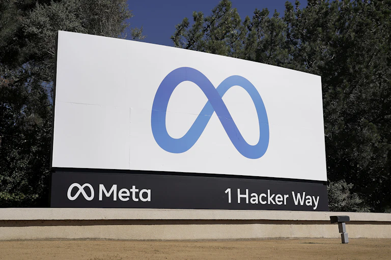 A ground-level billboard with an infinity-sign-like corporate logo