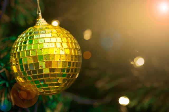 Yellow Christmas bauble on a tree