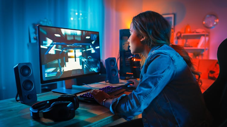 A young woman plays a computer game.