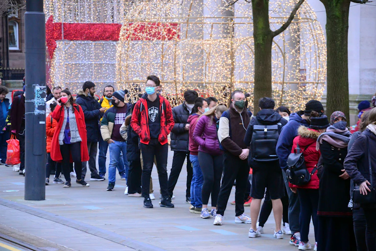 People in Manchester queuing for their COVID booster.