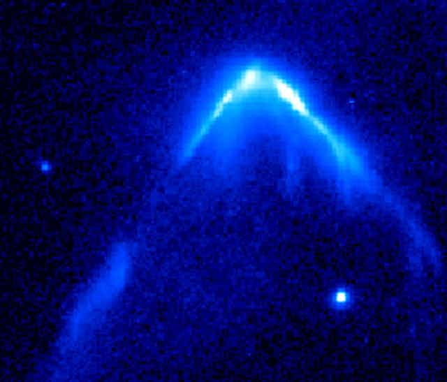 Telescopic view of blazing light in an inverted 'v' shape with a bright star at the front.