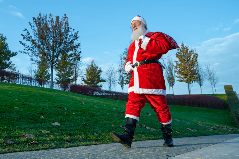 Santa Claus out for a walk in the park.