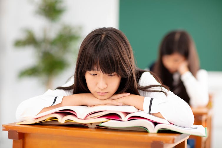 Girl looking bored and tired in class