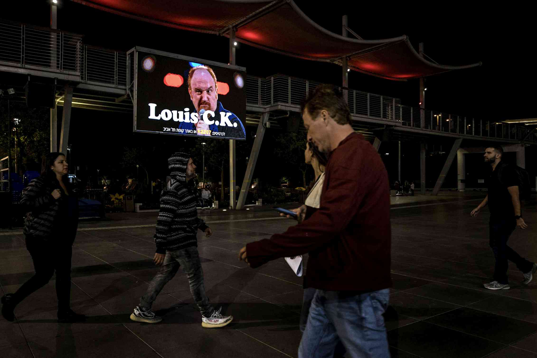 A billboard showing comedian Louis C.K.