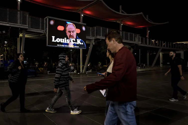 A billboard showing comedian Louis C.K.