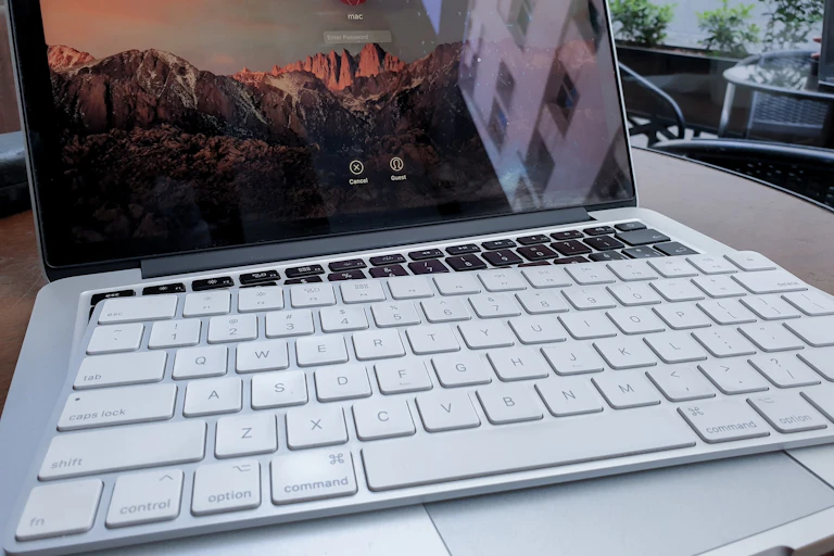 Ordinateur portable ouvert, un clavier mac recouvrant le clavier intégré