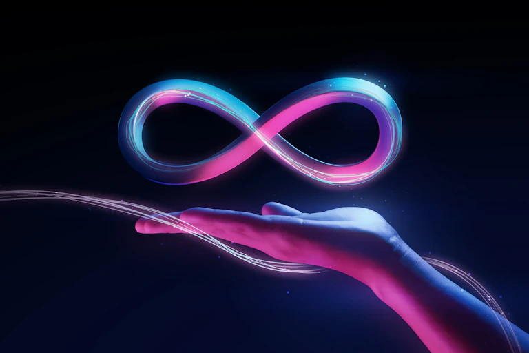 A woman's hand with the infinity sign floatiing above it, to represent the metaverse.