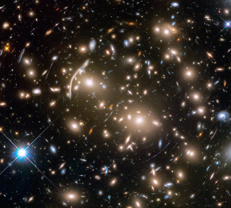 Abell 370 is a cluster of hundreds of galaxies about five billion light years away from Earth. NASA, ESA, and J. Lotz and the HFF Team (STScI)